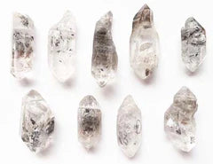 Nine small tibetan quartz points arranged in a grid formation for healing purposes